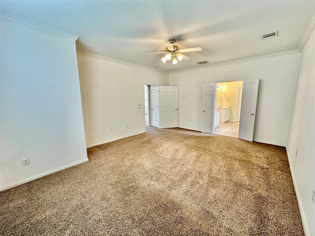 unfurnished bedroom with ensuite bathroom, visible vents, ornamental molding, and light colored carpet