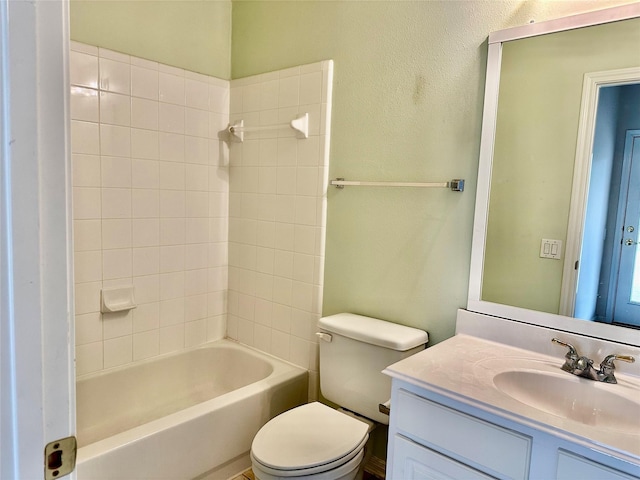 full bath featuring bathtub / shower combination, a textured wall, vanity, and toilet