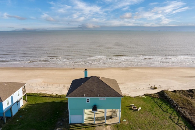 aerial view with a water view and a beach view