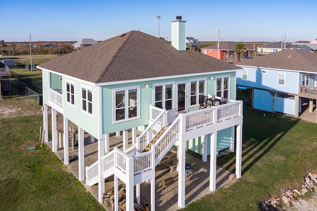 back of house with a yard, a deck, and a patio area