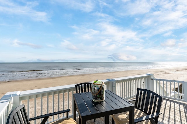 deck with a water view and a beach view