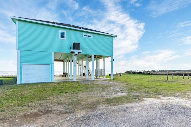 rear view of house with a garage and a carport