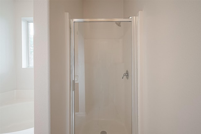 bathroom featuring plus walk in shower