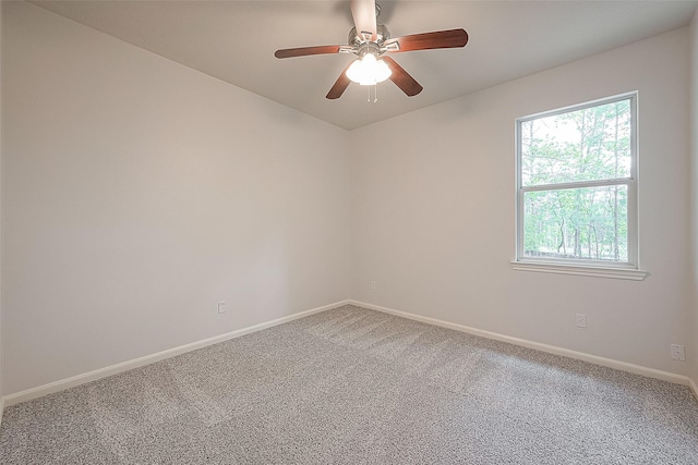 spare room featuring ceiling fan and carpet