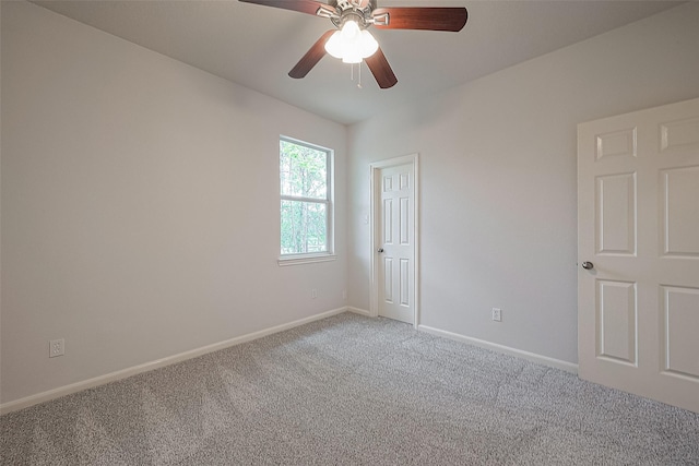 carpeted empty room featuring ceiling fan