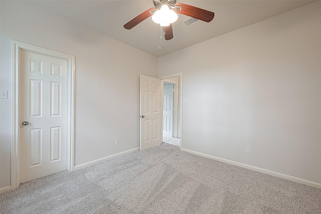 carpeted spare room with ceiling fan