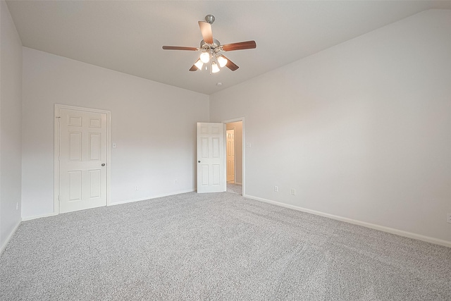 spare room featuring ceiling fan, carpet floors, and lofted ceiling