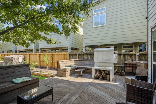 deck featuring exterior fireplace