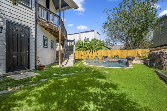 view of yard with pool water feature, a fenced in pool, and a balcony