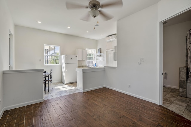 kitchen featuring white cabinets, ceiling fan, white refrigerator, and kitchen peninsula