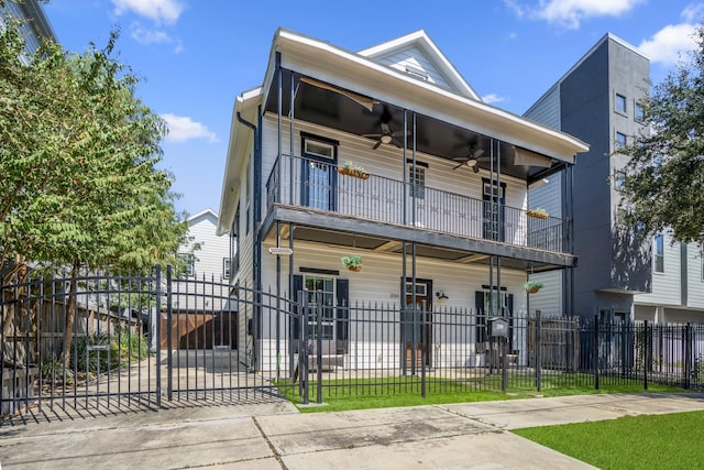 view of front of home featuring a balcony and ceiling fan