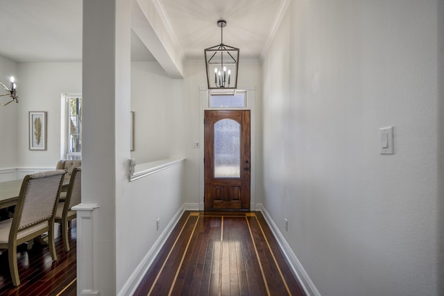 entrance foyer featuring a chandelier, hardwood / wood-style flooring, and crown molding