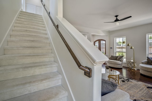 staircase featuring hardwood / wood-style flooring and ceiling fan