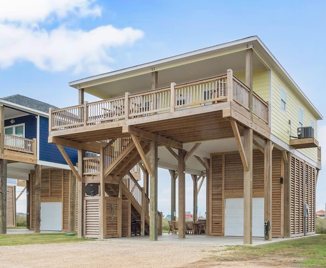 exterior space with a deck, central air condition unit, and a garage