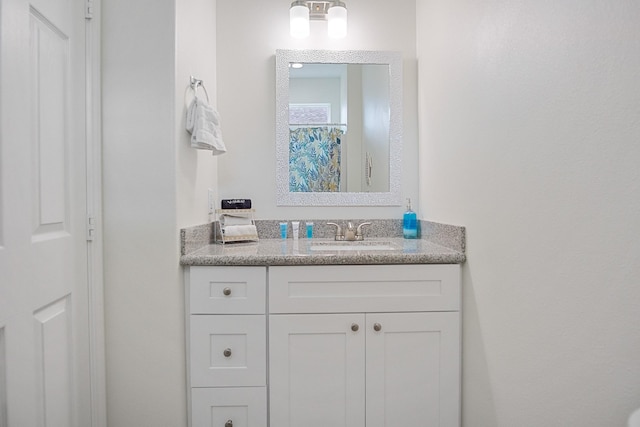 bathroom with walk in shower and vanity