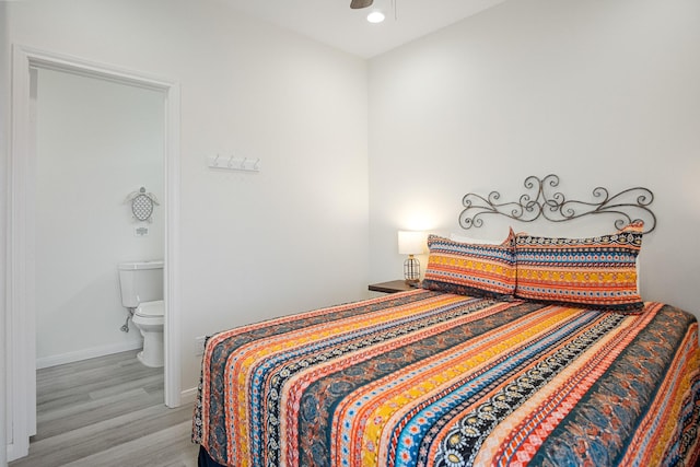 bedroom featuring light hardwood / wood-style flooring and connected bathroom