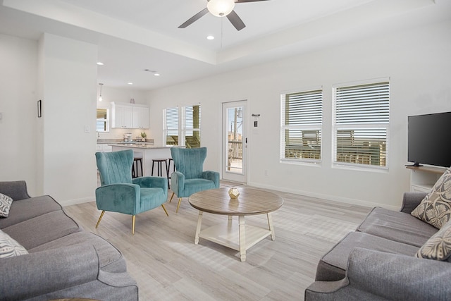 living room featuring ceiling fan and light wood-type flooring