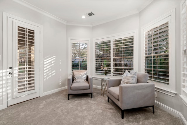 living area with crown molding and light carpet