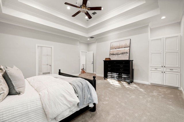 bedroom with a raised ceiling, ceiling fan, light colored carpet, and ornamental molding