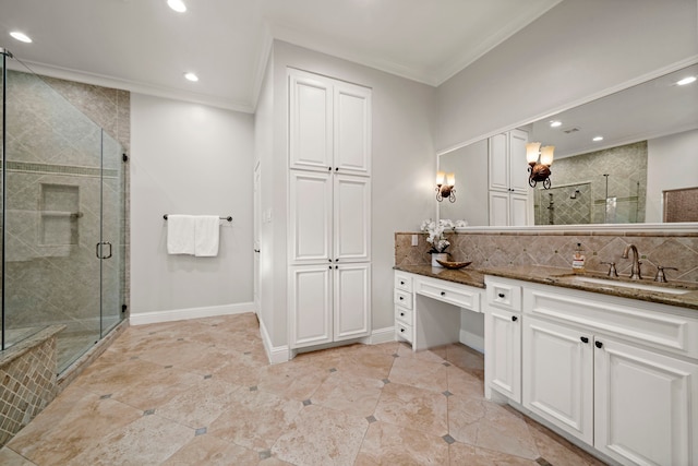 bathroom with decorative backsplash, a shower with door, vanity, and ornamental molding