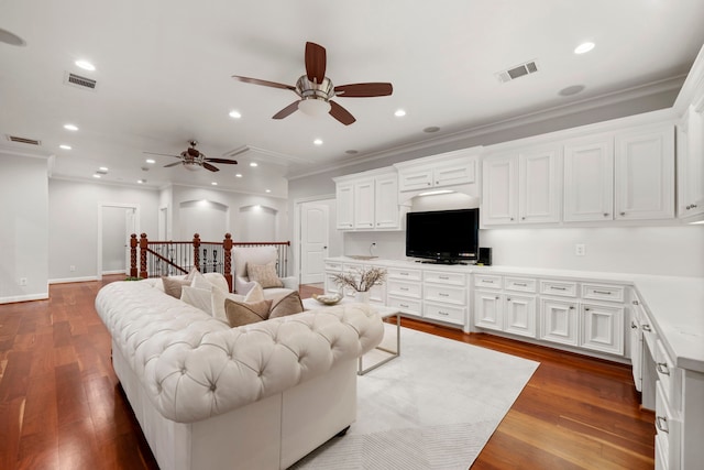 living room with ceiling fan, dark hardwood / wood-style flooring, and crown molding