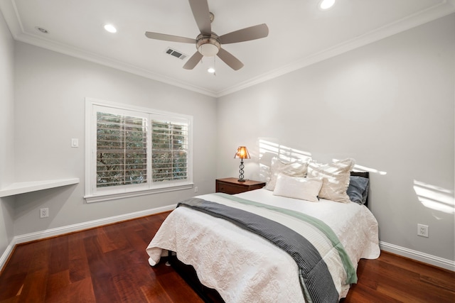 bedroom featuring dark hardwood / wood-style flooring, ceiling fan, and crown molding