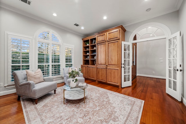 sitting room featuring crown molding, french doors, and dark wood-type flooring