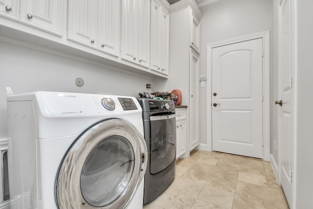 laundry area with cabinets and separate washer and dryer