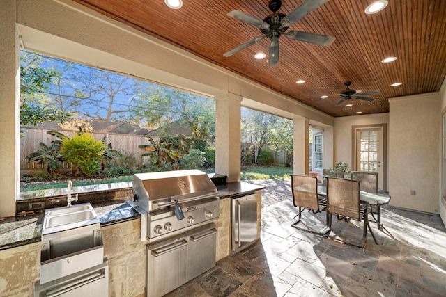 view of patio featuring area for grilling and ceiling fan