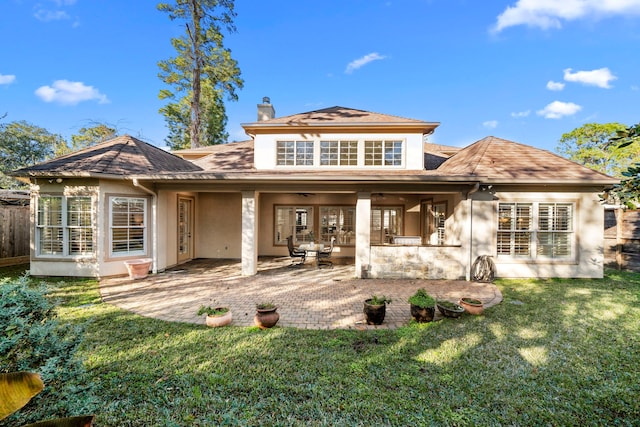 rear view of house featuring a yard and a patio