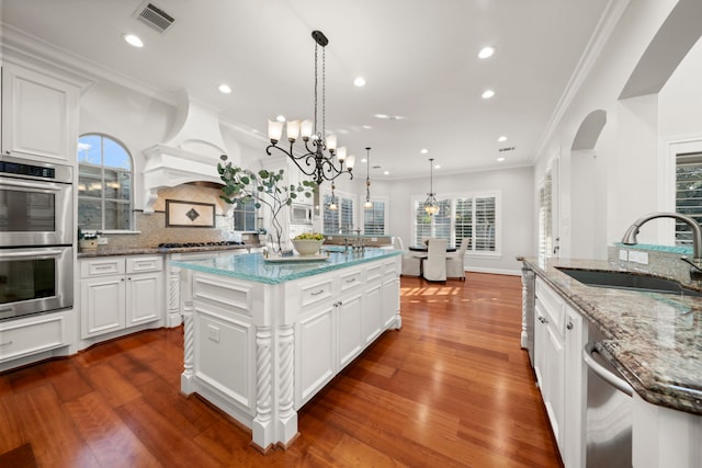 kitchen with white cabinetry, a spacious island, and appliances with stainless steel finishes