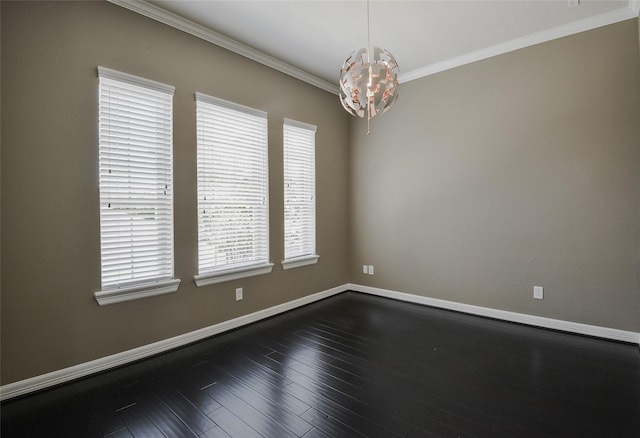 spare room featuring dark hardwood / wood-style flooring and crown molding