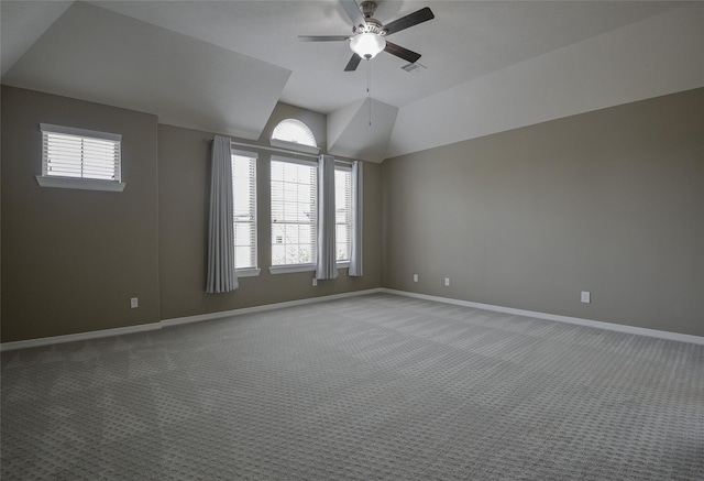 empty room featuring carpet floors, plenty of natural light, ceiling fan, and lofted ceiling