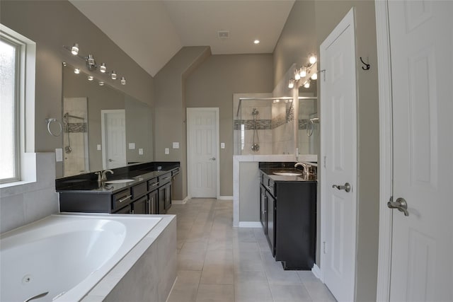 bathroom with tile patterned flooring, shower with separate bathtub, and vanity