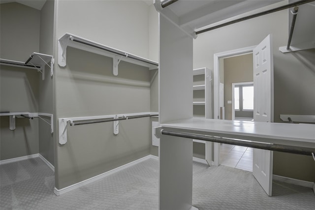 spacious closet with light colored carpet