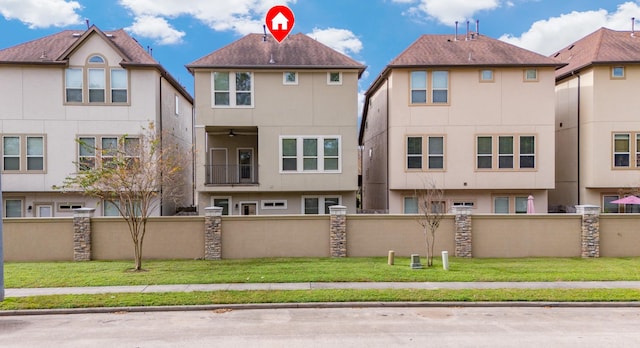 rear view of property with a yard