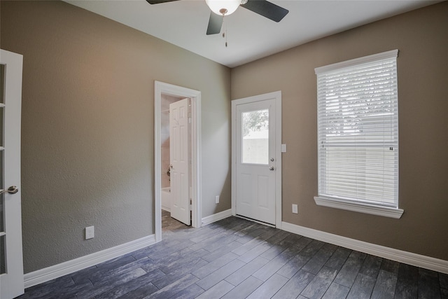 foyer with dark hardwood / wood-style floors and ceiling fan