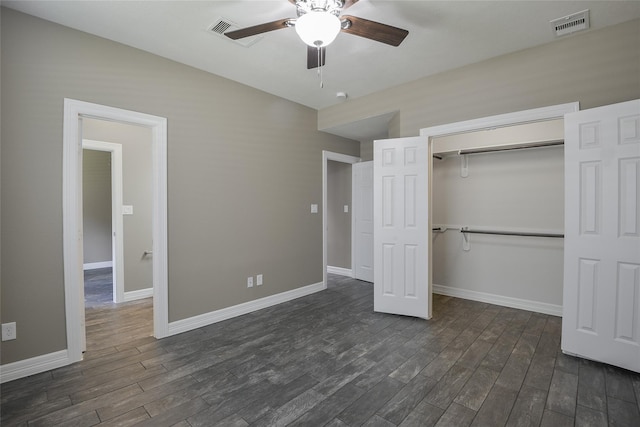 unfurnished bedroom featuring ceiling fan, a closet, and dark wood-type flooring