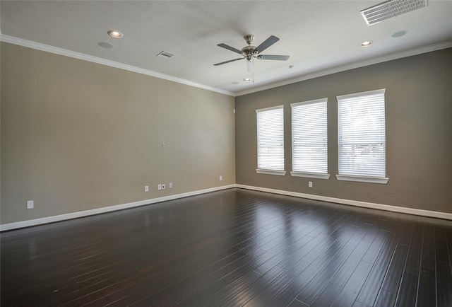 spare room featuring crown molding, plenty of natural light, and dark wood-type flooring