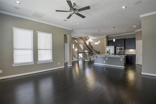 unfurnished living room featuring ceiling fan, dark hardwood / wood-style flooring, and crown molding