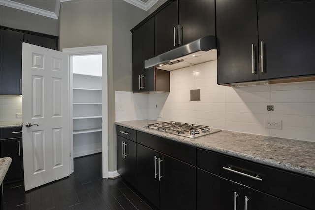 kitchen with backsplash, stainless steel gas stovetop, dark wood-type flooring, and ornamental molding