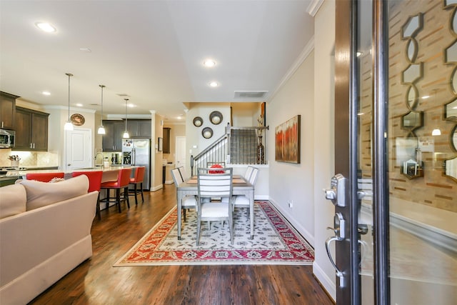 dining area featuring crown molding and dark wood-type flooring