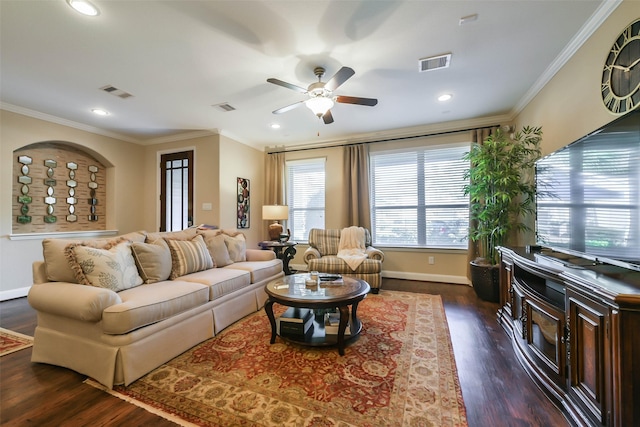 living room with crown molding, ceiling fan, and dark wood-type flooring