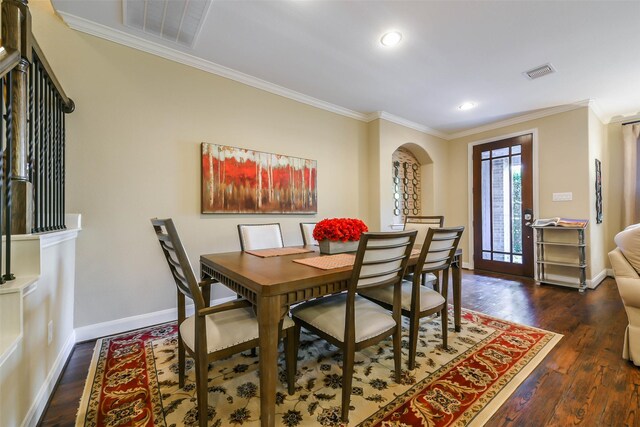 dining area with dark hardwood / wood-style floors and crown molding