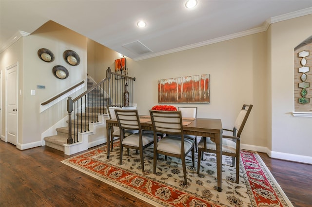 dining room with crown molding and dark hardwood / wood-style floors