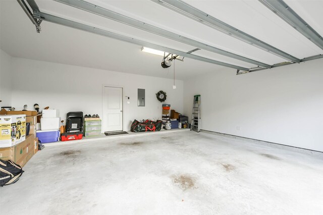 garage with a garage door opener and electric panel