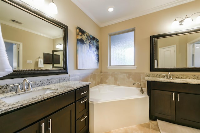 bathroom featuring tile patterned floors, a bathtub, vanity, and ornamental molding