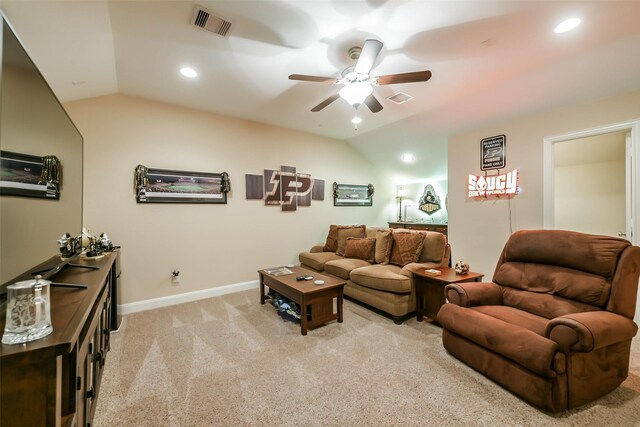 living room with ceiling fan, lofted ceiling, and light carpet