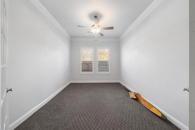 spare room with dark colored carpet, ceiling fan, and crown molding