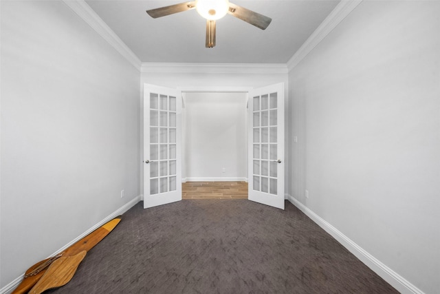 spare room featuring dark colored carpet, ceiling fan, ornamental molding, and french doors